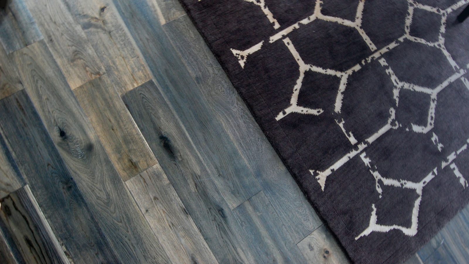 Area rug on dark brown hardwood floor