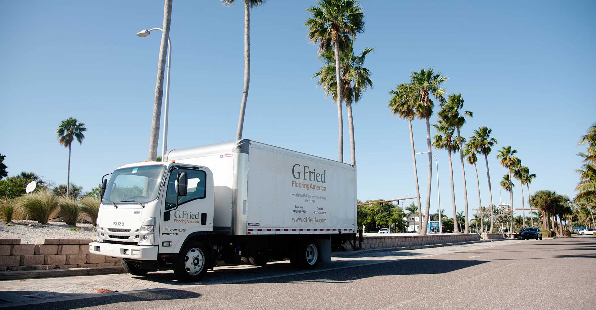 G. Fried truck parked below palm trees