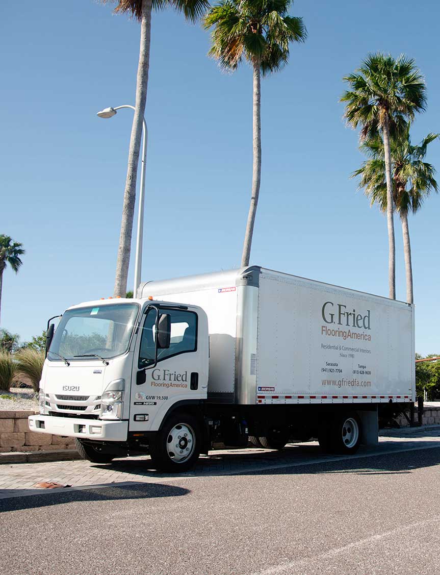G. Fried truck parked below palm trees